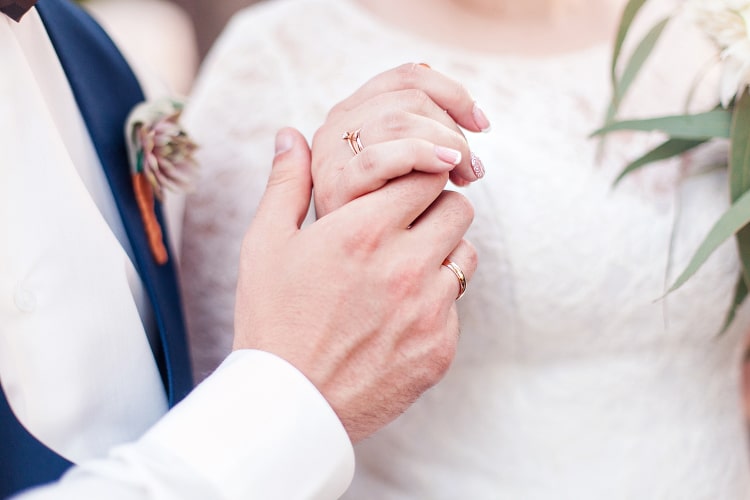 Bride and groom with wedding bands